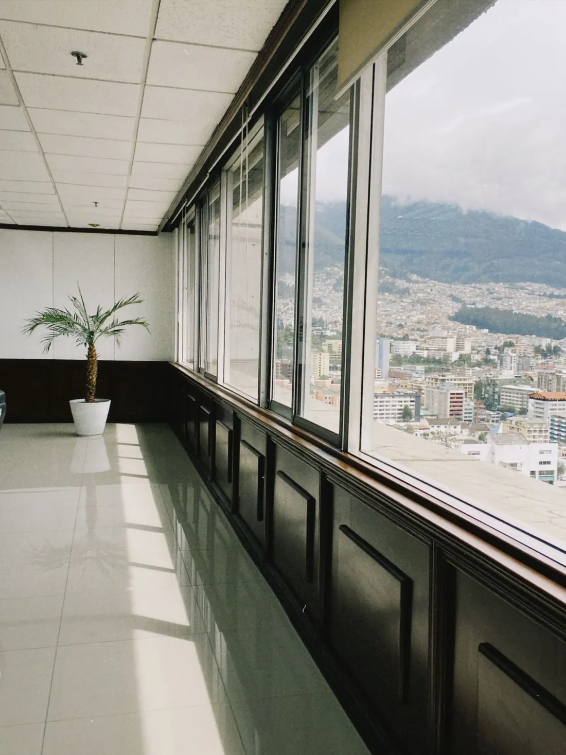Office interior with a wall of glass and the floor left clear